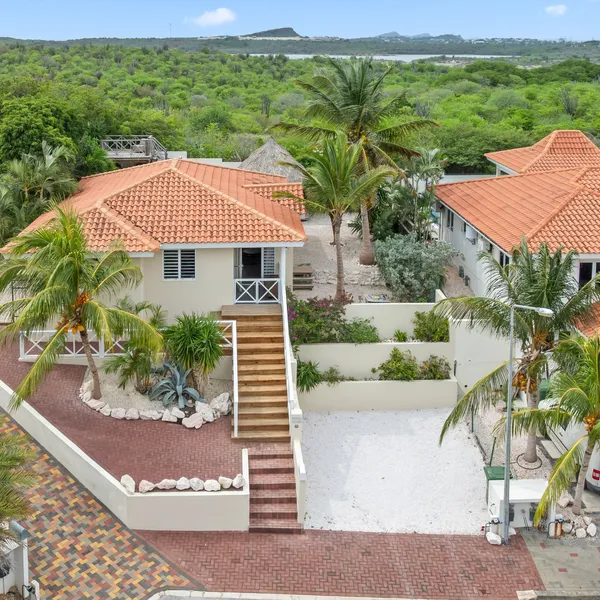 Aerial view of the home with front garden and outdoor stairs — Marbella Estate H11, Curaçao.